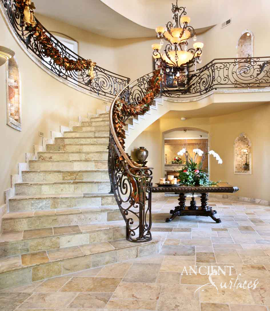 Antique stone flooring and stair treads in a curved entry hall