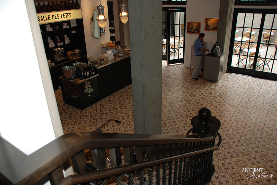 Reclaimed encaustic cement tile floor in faded period colours