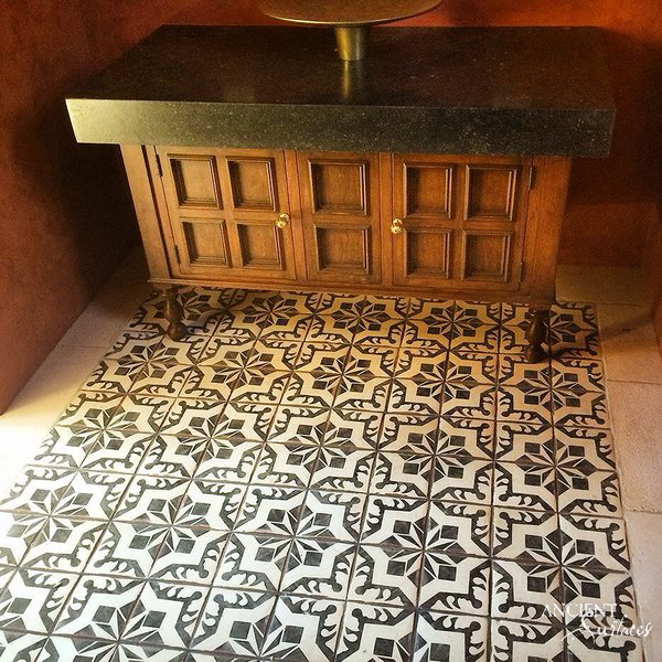 Antique cement tiles arranged in a repeating star pattern