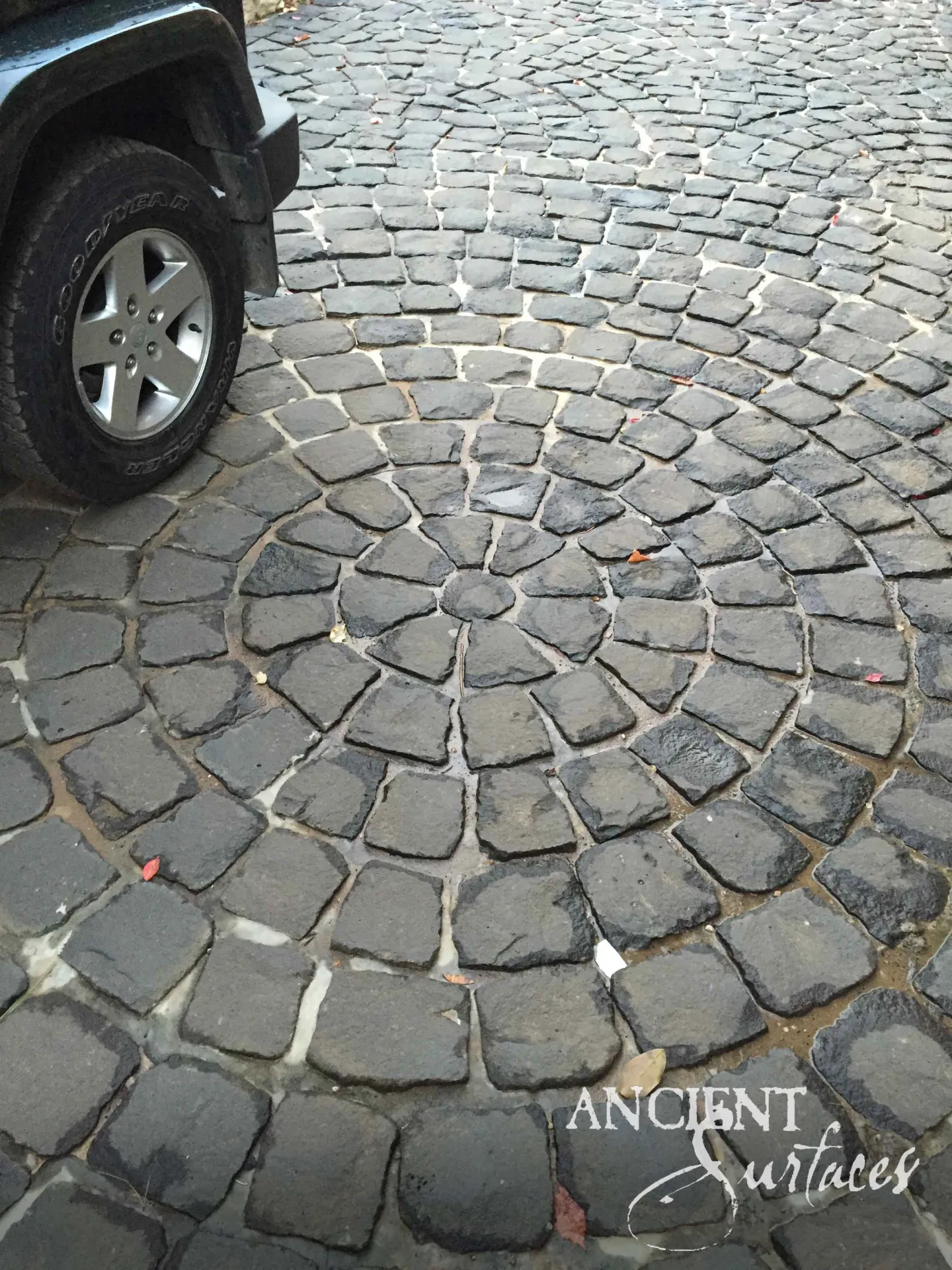Antique basalt cobblestone paving in a courtyard setting