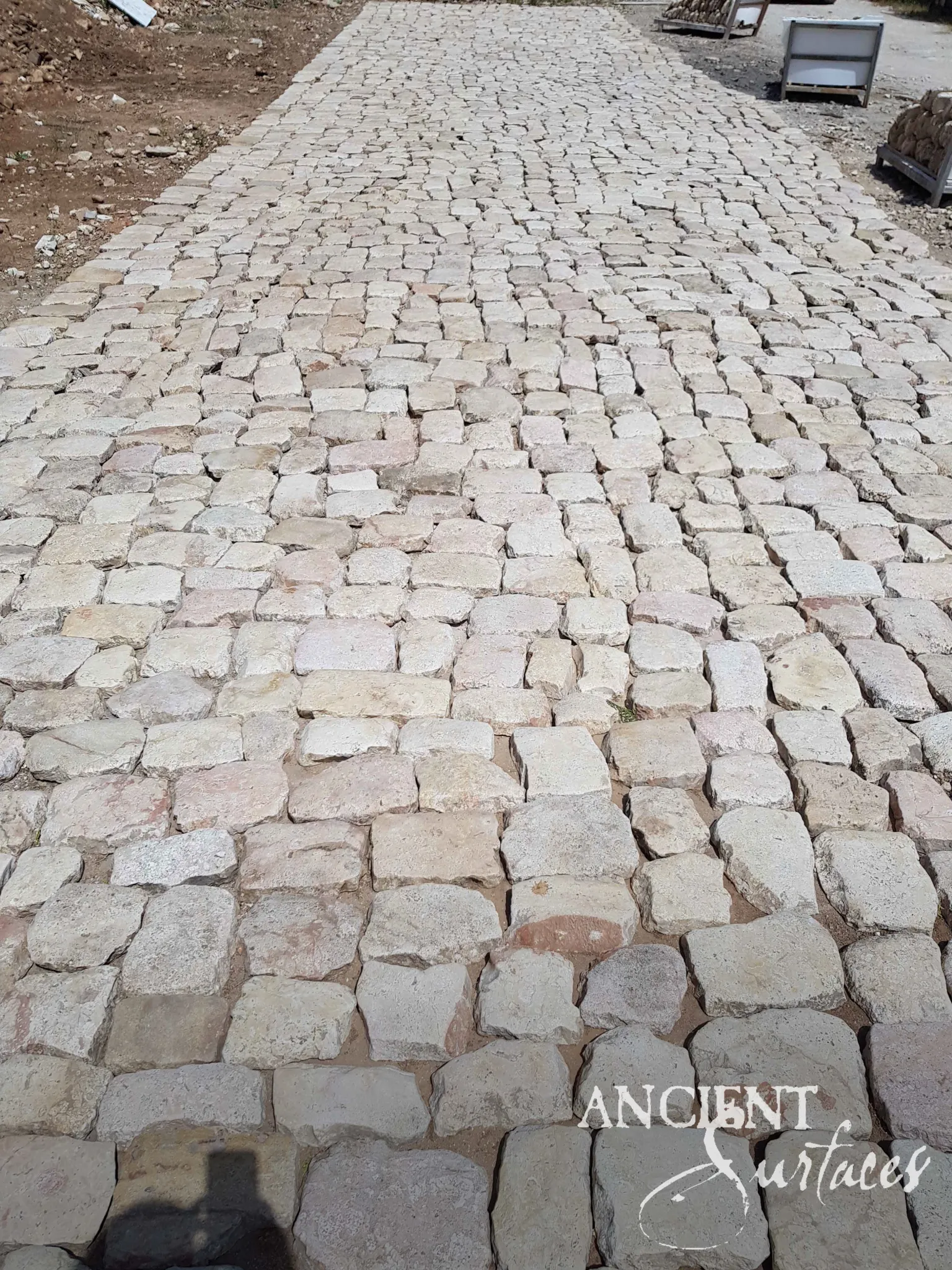 Reclaimed cobblestones set as a driveway surface